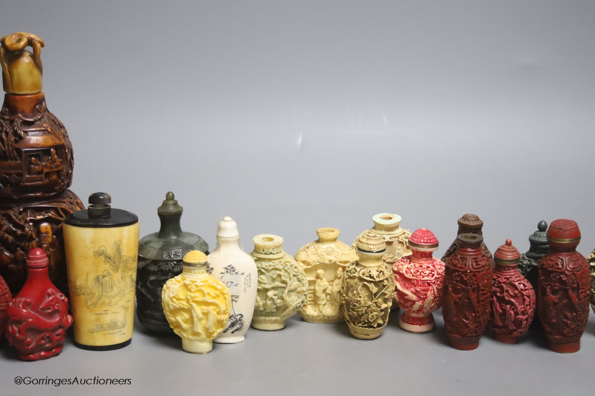 A large Chinese 20th century carved snuff bottle and smaller snuff bottles